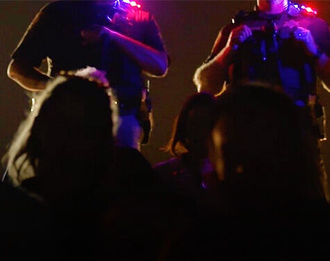 security guards wearing guardian angel safety lights in front of a crowd of people