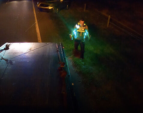 person standing by a tow truck wearing guardian angel devices