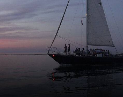 people on a boat with a guardian angel device attached to the boat