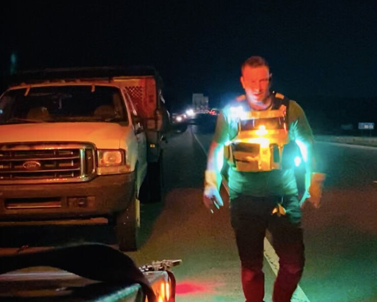 Tow truck driver using a Guardian Angel light