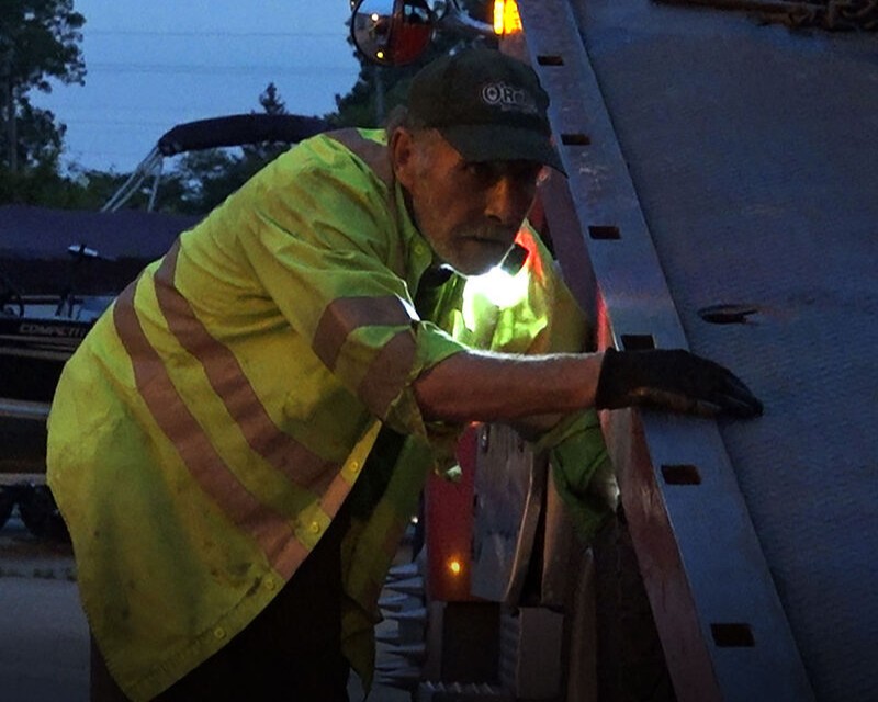Tow truck driver wearing a Guardian Angel light