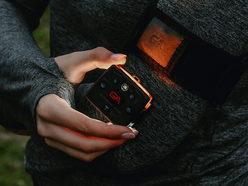A college student holding their Guardian Angel light